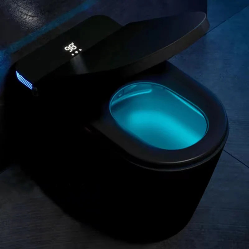 A modern, high-tech black smart toilet and bidet with blue LED lighting around the lid, featuring a sleek design and a digital display on the lid.